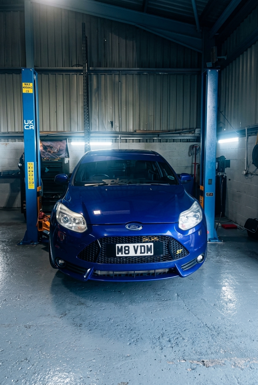 Technician working on a modern vehicle inside the PR7 MOT Centre workshop