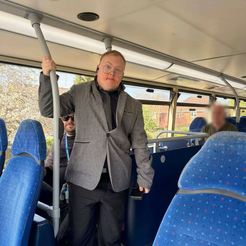 Someone we support travelling confidently by bus, smartly dressed.
