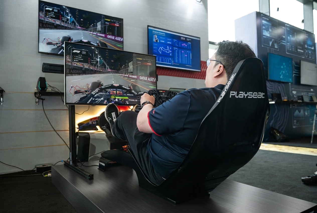 Armand driving a racing simulator surrounded by multiple screens