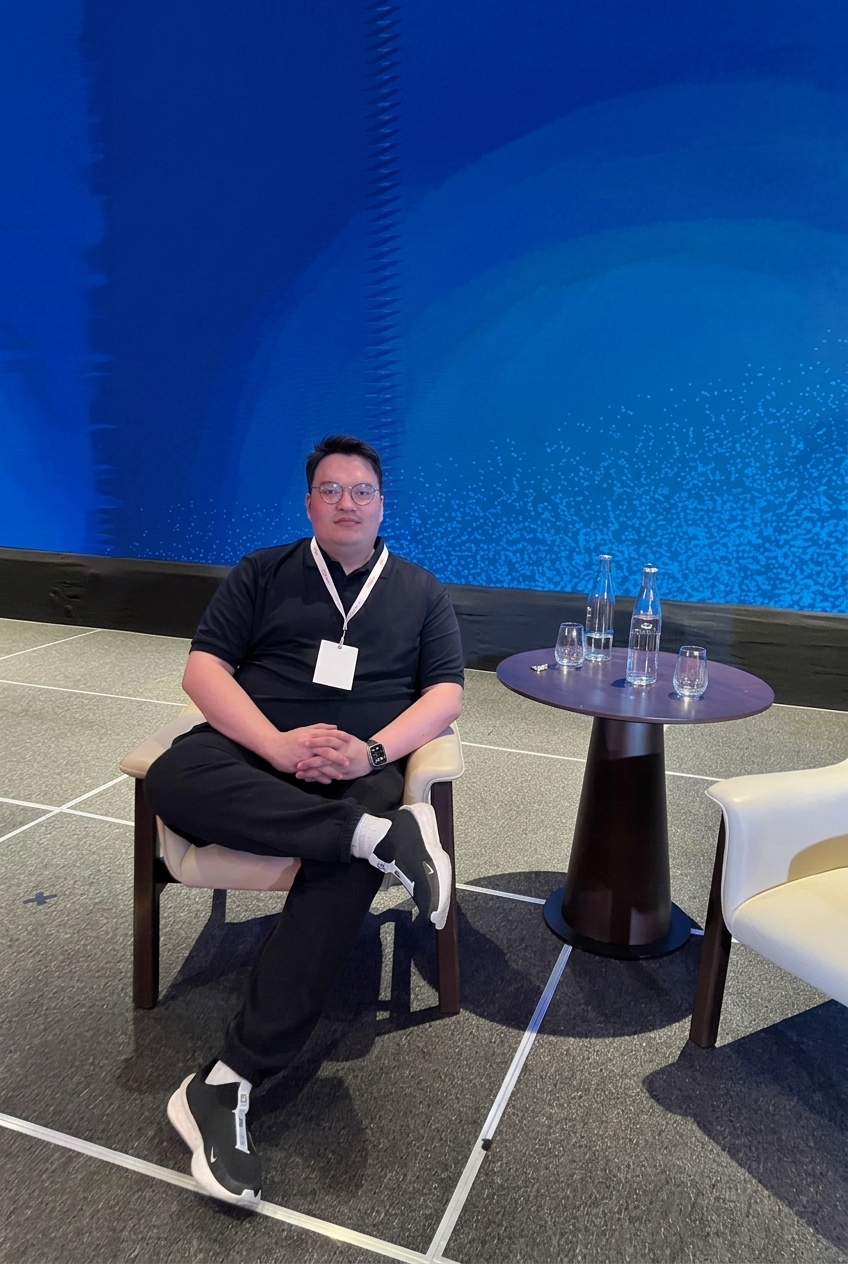 Armand seated at a technology event