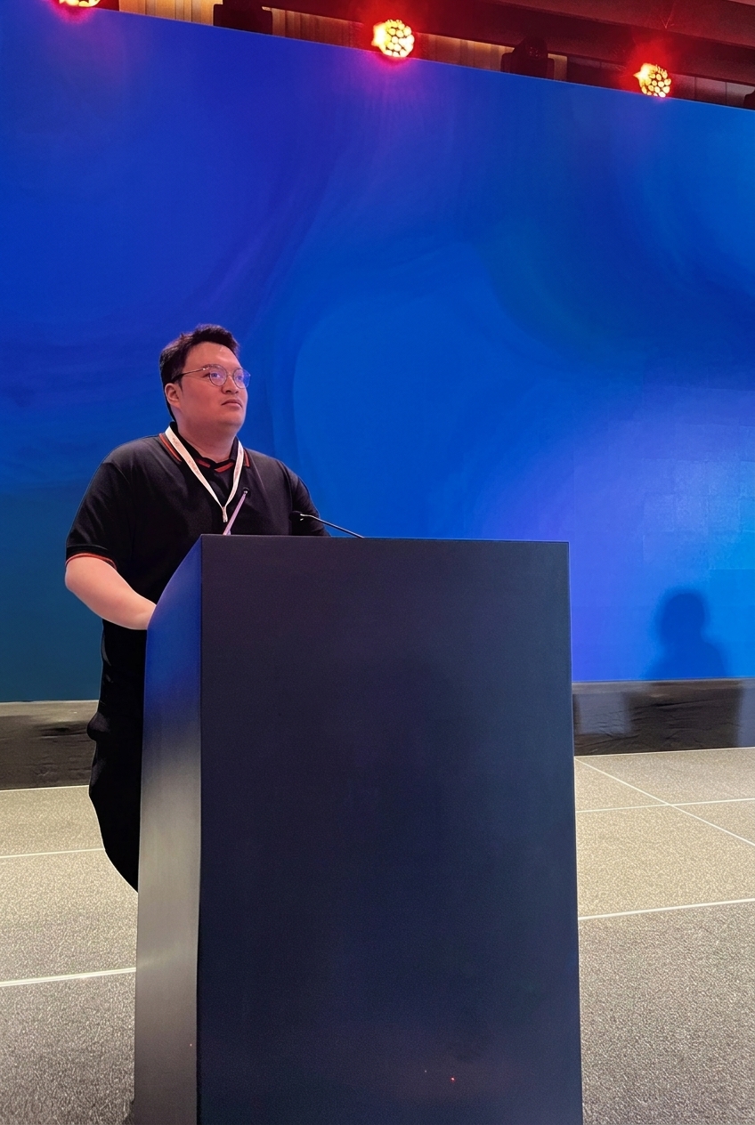 Armand speaking on a technology stage
